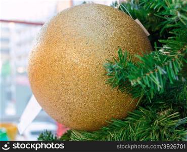 big golden sparkly christmas ball hanged on xmas tree