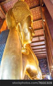 Big golden statue of Reclining Buddha in temple Wat Pho. Bangkok, Thailand