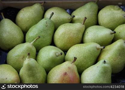 Big green pears at a market stall in the Provence, France
