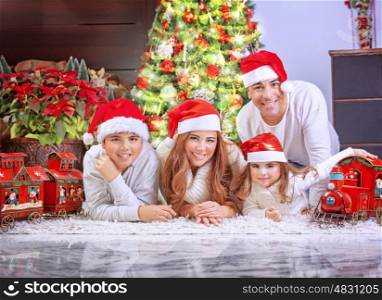 Big happy family wearing Santa hat, celebrating Xmas at home near beautiful decorated Christmas tree, spending winter holidays together concept