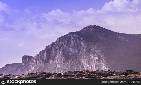 Big huge mountain against summer sky with clouds. Beauty in nature concept.. Mountain cliffs against sky with clouds