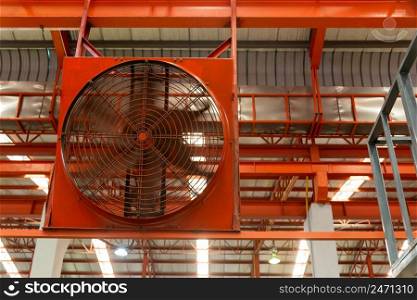 Big industrial cooler red fans in factory for reduced heat in operation ventilation of plant, industry cooling mechanical fan