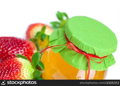 big juicy ripe strawberries and jar of honey isolated on white