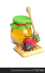 big juicy ripe strawberries in chocolate, a jar of honey and waffles isolated on white