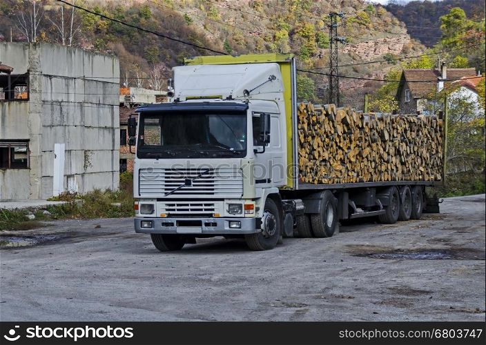 Big lorry carry stack firewood in Lakatnik, Bulgaria