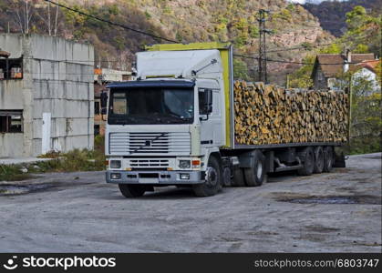 Big lorry carry stack firewood in Lakatnik, Bulgaria