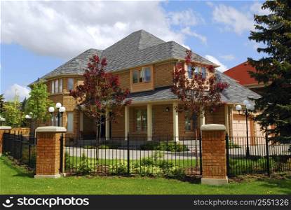 Big luxury residential house with iron fence