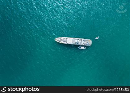 Big luxury yacht anchoring on water, aerial view. Active life style, water transportation and marine sport