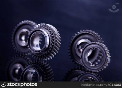 Big metal gears. Big metal gears on glossy black background