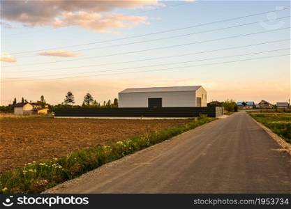 Big metal industrial storage shed building. Exterior of warehouse, no brands on storehouse with copy space.