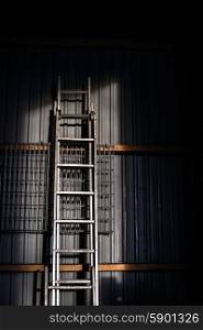 Big metal ladder stadning up against af wall