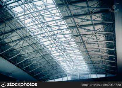 Big metal roof with long panoramic windows at airport terminal