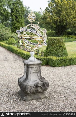 big metal sundial in english garden