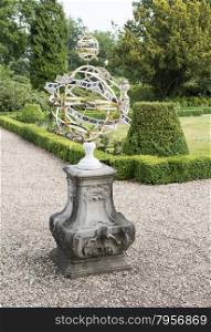 big metal sundial in english garden