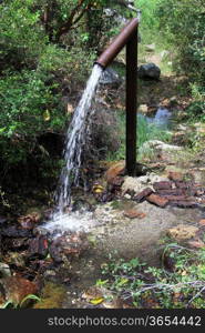 Big metal tube with water in the forest, Turky