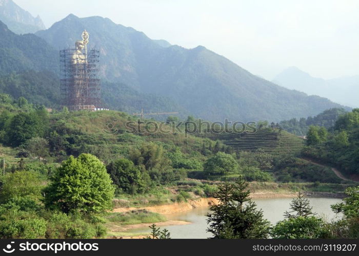 Big new statue of buddha Di Zang near Jiuhua Shan village, China