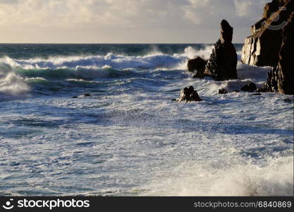 Big ocean wave crashing rock