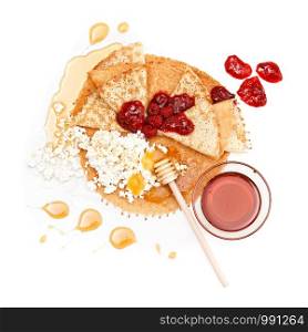 Big pancake decorated with berries, chocolate chips, honey cream