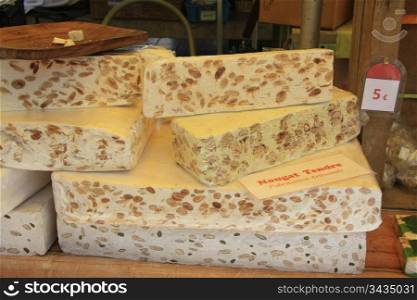 Big pieces of fresh made nougat on a market in the Provence, France