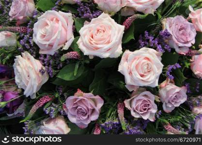 big pink roses in a mixed flower arrangement