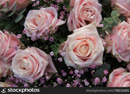 Big pink roses with waterdrops in a floral arrangement