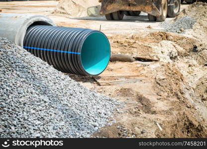 Big pipe or tube for water sewer on construction site during road repair