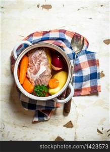 big pot of soup with meat and fresh vegetables. On rustic background.. big pot of soup with meat and fresh vegetables.