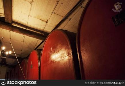 Big red barrels for wine in a cellar