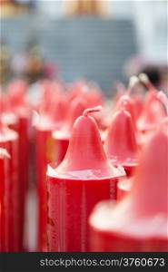 Big red candles lined up in a row a lot. The measured area For use in rituals