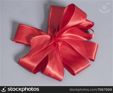 Big Red satin gift bow. Ribbon. Isolated on gray background