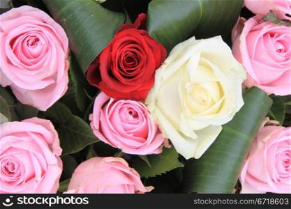 Big red, white and pink roses in a mixed rose bouquet