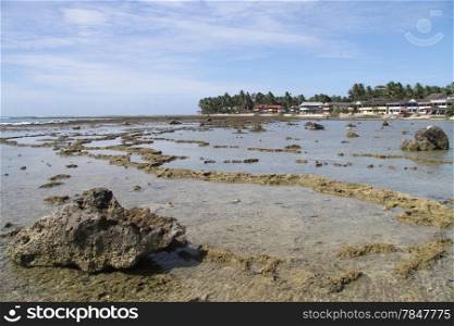 Big rock and low tide on Pantai Sorake beach in Nias island, Indonesia