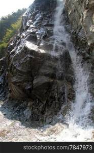 Big rock and small waterfall in Nepal
