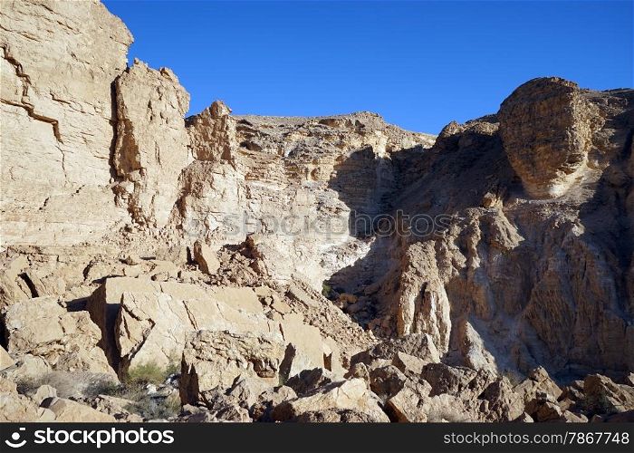 Big rock on the edge of mount in NEgev desert, Israel