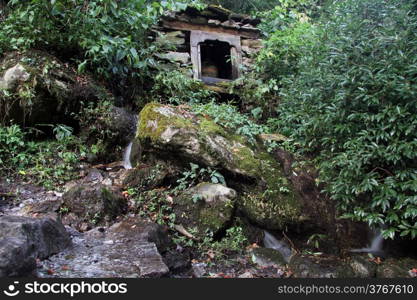 Big rocks and spring near water mill in Nepal