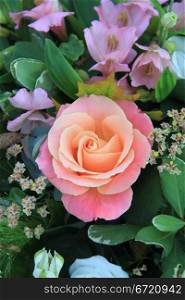 big rose in different shades of pink in a floral arrangement