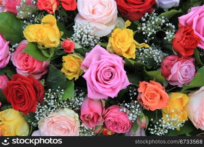 Big roses in various colors in a mixed rose arrangement