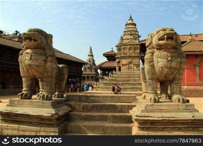 Big sandstone lions and durbar square in Bhaktapur, Nepal