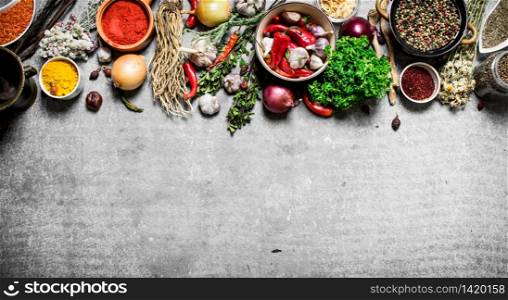 Big set of spices and herbs. On a stone background.. Big set of spices and herbs