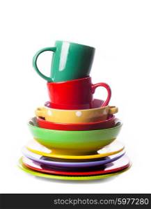 Big stack of different colors mugs and plate on white background, one above the another