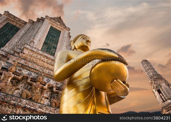 Big statue of Golden Buddha in Wat Arun or Temple of Dawn. Thai traditional Buddhist architecture in Bangkok, Thailand