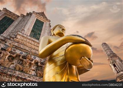 Big statue of Golden Buddha in Wat Arun or Temple of Dawn. Thai traditional Buddhist architecture in Bangkok, Thailand