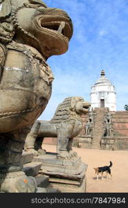 Big stone lions nd dog in durbar square in Bhaktapur, Nepal