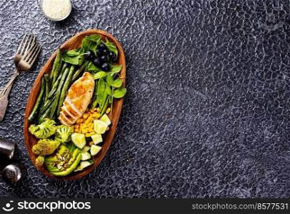 Big summer dinner with grilled chicken, green beans , corn and other vegetables