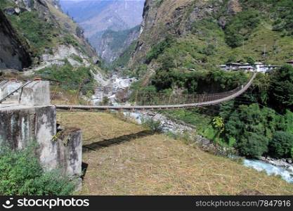 Big suspension bridge near village on the Annapurna trail in Nepal