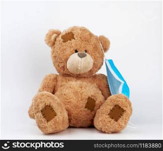 big teddy bear are sitting in white medical masks on a white background. Respiratory medicine.