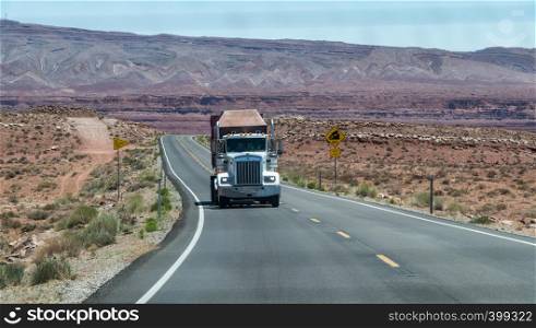 Big truck speeding up along Arizona road, united States.