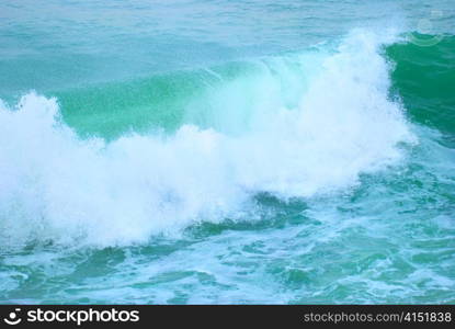 Big wave with sea foam and blue water