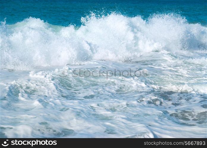 Big wave with sea foam and blue water