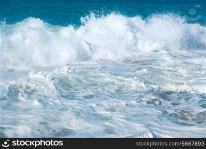 Big wave with sea foam and blue water